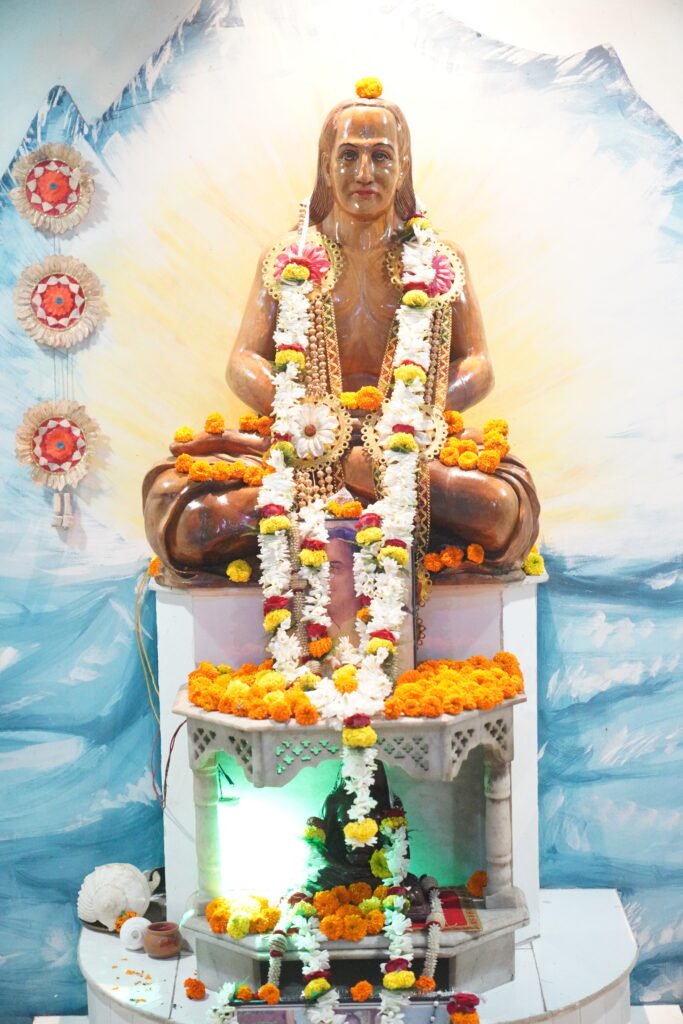 Mahavatar Babaji murti with marigold rose garlands Himalayan backdrop kumkum incense at Universal Peace Centre ashram Lachhipur Sunyoga 2026